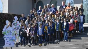 <p>Gruppenfoto der Kinder, Lehrpersonen und Politiker vor dem Parlament in Eupen, die beim Projekt „Zug der Demokratie“ dabei waren.</p>