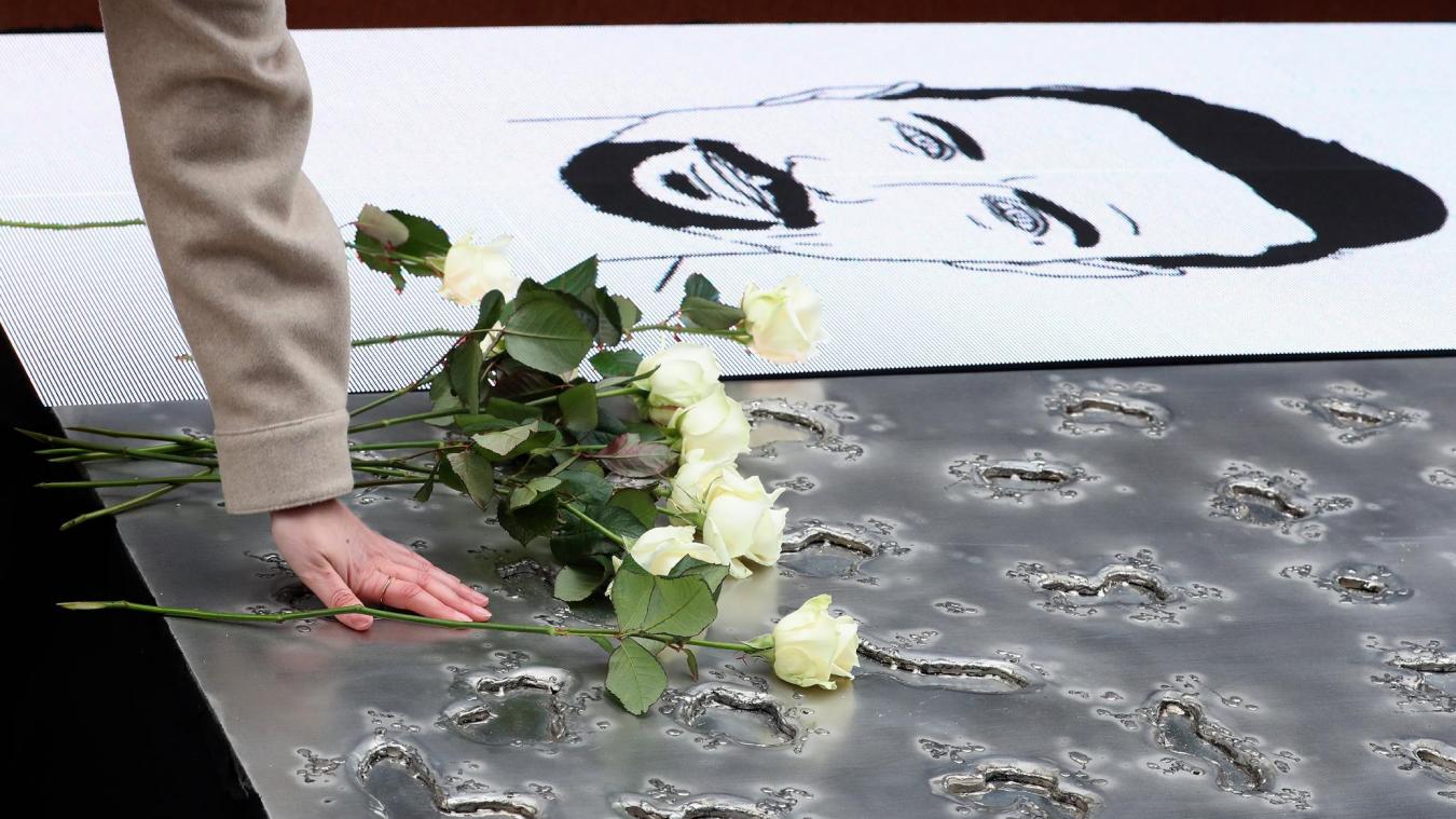 <p>Eine Hinterbliebene legt eine weiße Rose auf dem Monument in Erinnerung an die Opfer der Terroranschläge in Brüssel nieder.</p>