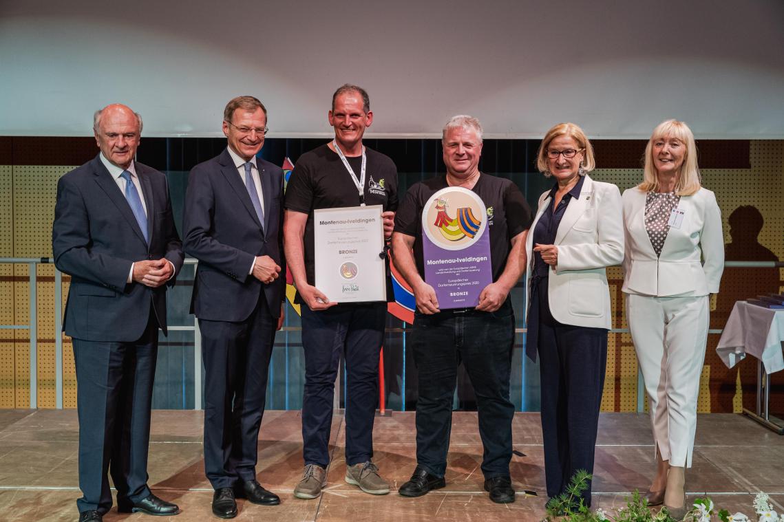 <p>Roger Kohnen und Pascal Mertes von der Dorfgemeinschaft Montingen (Mitte) bekamen den Preis überreicht.</p>