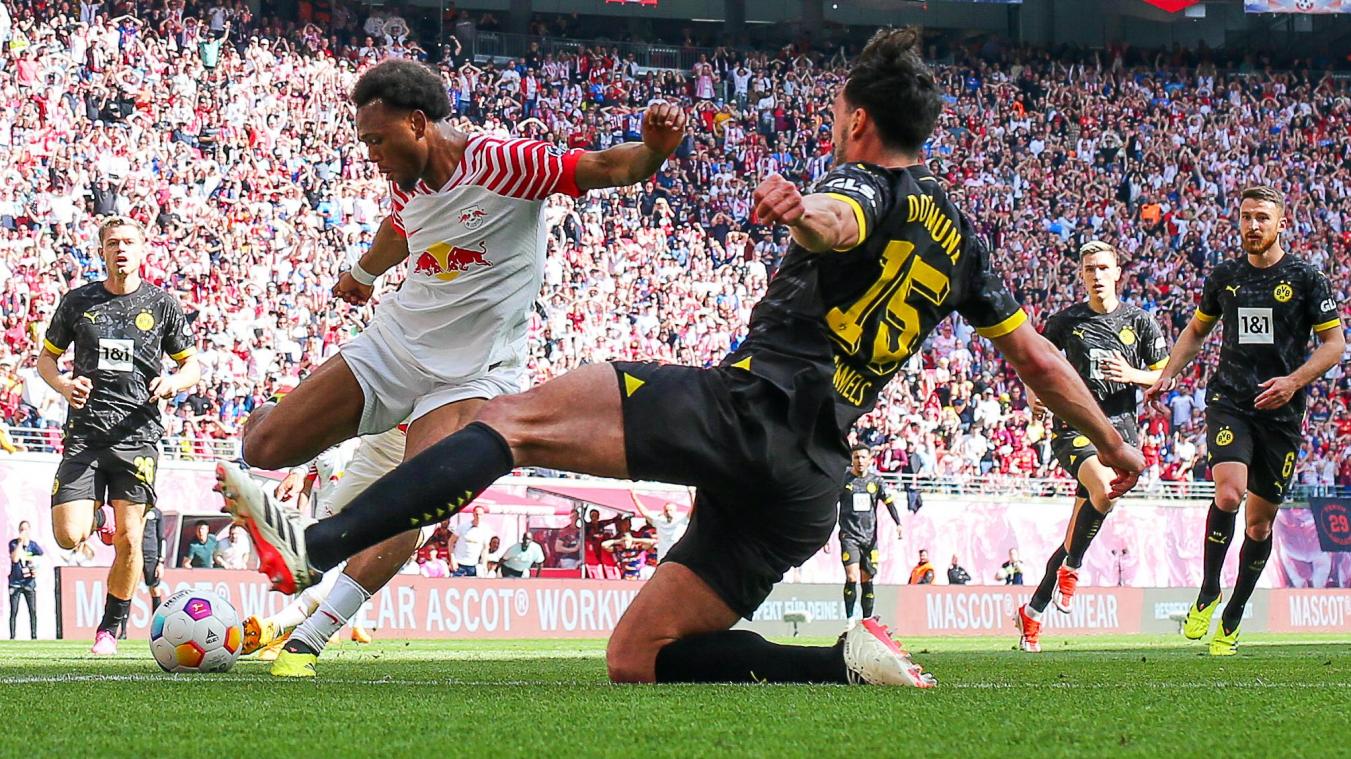 <p>Leipzigs Lois Openda (l.) und Dortmunds Mats Hummels kämpfen um den Ball.</p>