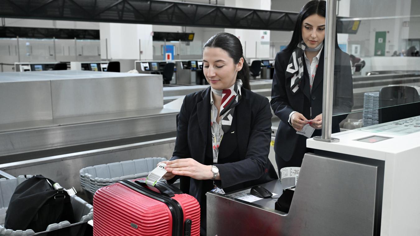 <p>Ein Mitarbeiter der Abfertigungsgesellschaft Aviapartner am Landesflughafen in Zaventem bringt einen Gepäckanhänger an einem Koffer an.</p>
