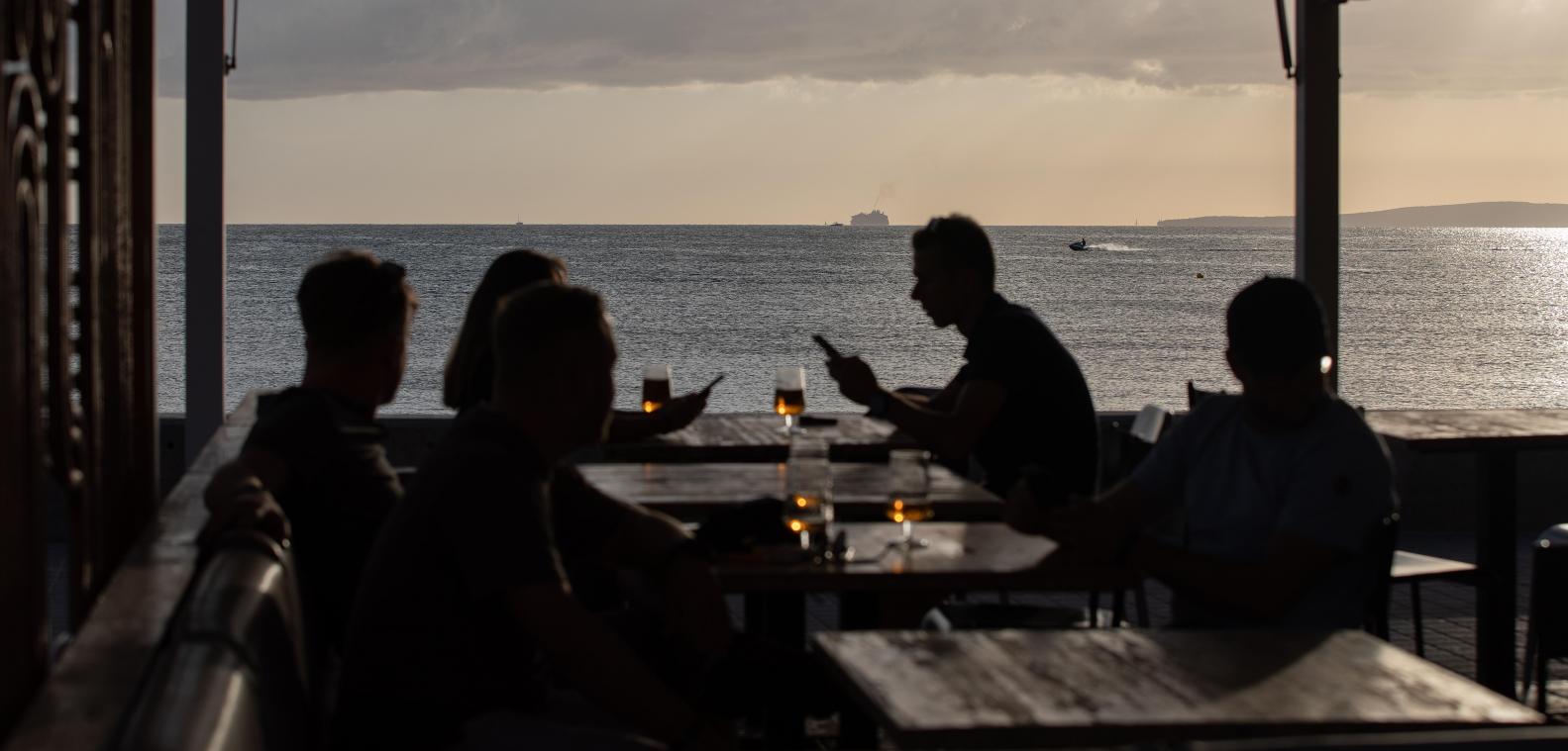 <p>Menschen den Sonnenuntergang auf einer Terrassenbar am Strand von Arenal in Mallorca: Der Krieg im Nahen Osten verändert die Urlaubspläne der Belgier.</p>