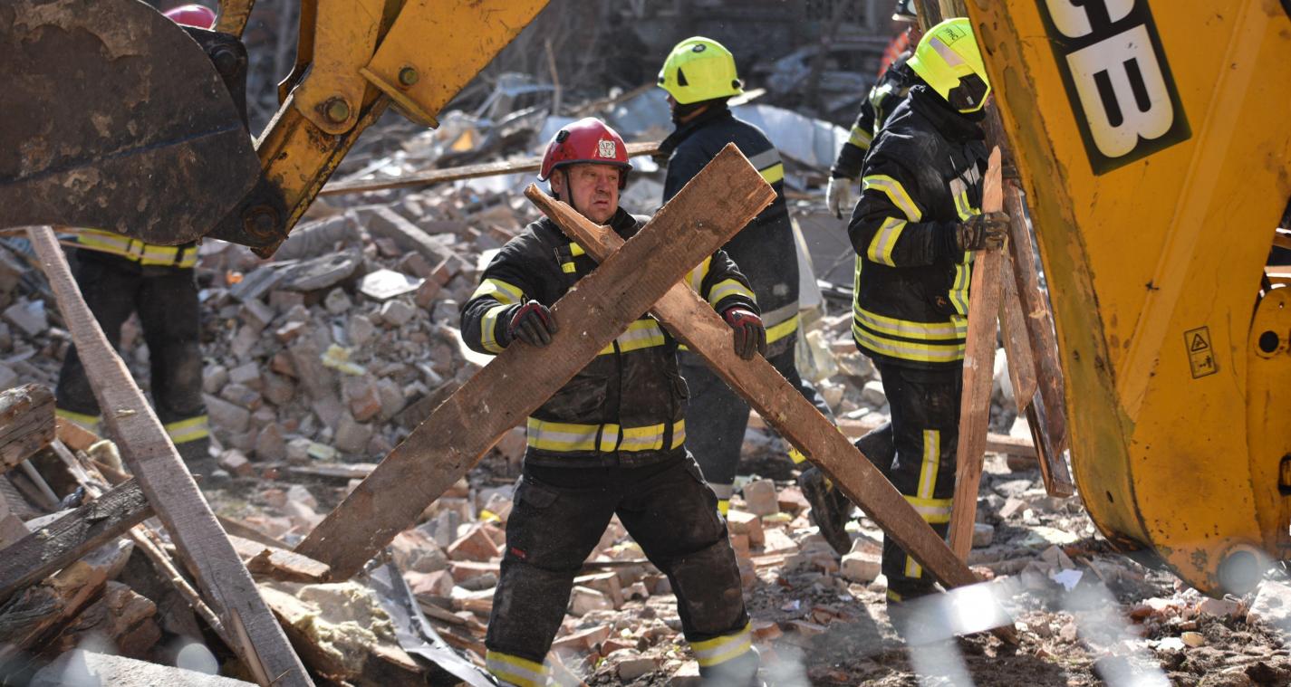 <p>Eine Rettungskraft räumt die Trümmer nach einem russischen Angriff auf ein Wohnviertel weg.</p>