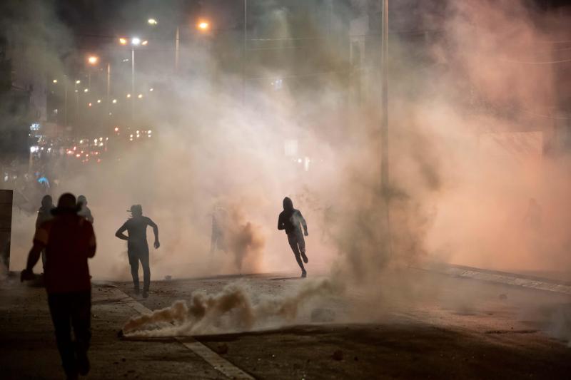 <p>Demonstranten fliehen vor Tränengaskanistern, die von der israelischen Grenzpolizei nach einem Anti-Israel-Protest abgefeuert wurden.</p>