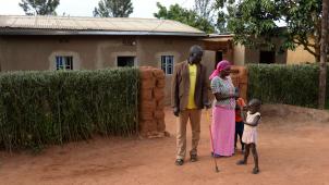<p>Jean Giraneza und Marie-Jane Uwimana mit zwei ihrer vier Kinder vor ihrem Haus in Rweru.</p>