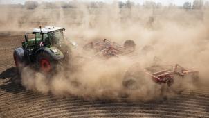 <p>A tractor with an agricultural implement attached drives across a parched field as it raises a cloud of dust near Beelitz, eastern Germany, on August 18, 2022.<br />
JENS SCHLUETER / AFP</p>