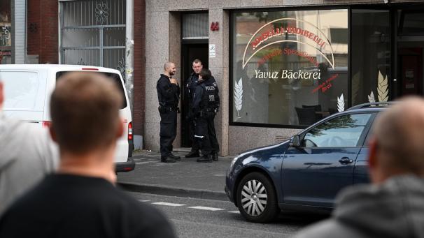 <p>Polizeibeamte stehen vor einem Haus in der Josef-Schregel-Straße in Düren, das wegen Terrorverdachts durchsucht wird.</p>