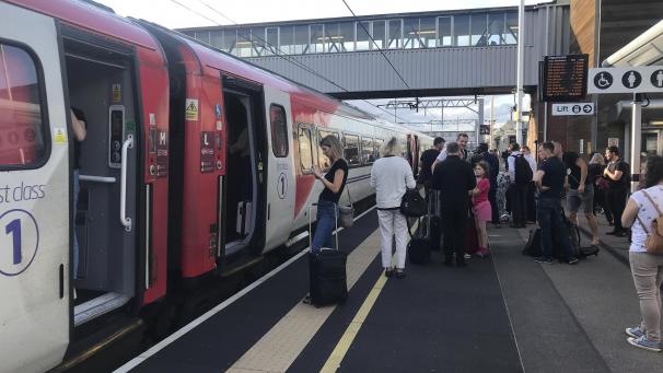 <p>Zugpassagiere warten auf englischen Bahnhöfen auf Nachrichten, da der Reiseverkehr wegen der Strompanne eingestellt ist.</p>
