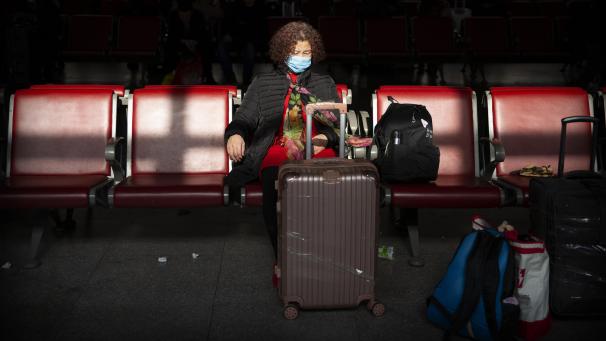 <p>Eine Reisende trägt Mundschutz als Schutzmaßnahme gegen die Verbreitung des Corona-Virus, während sie in einem Warteraum am Pekinger Westbahnhof sitzt.</p>