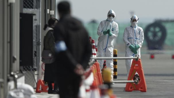 <p>Beamte in Schutzanzügen stehen in der Nähe des Kreuzfahrtschiffs „Diamond Princess“ im Hafen von Yokohama. An Bord des unter Quarantäne gestellten Kreuzfahrtschiffes in Japan sind weitere 41 Fälle des neuen Coronavirus festgestellt worden.</p>