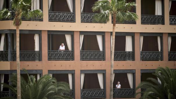 <p>Hotelgäste stehen auf den Balkonen des Hotels H10 Costa Adeje Palace auf Teneriffa.</p>
