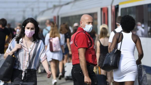 <p>Tagesausflügler unter dem wachsamen Auge eines SNCB-Sicherheitsbeamten am Bahnhof von Knokke-Heist.</p>