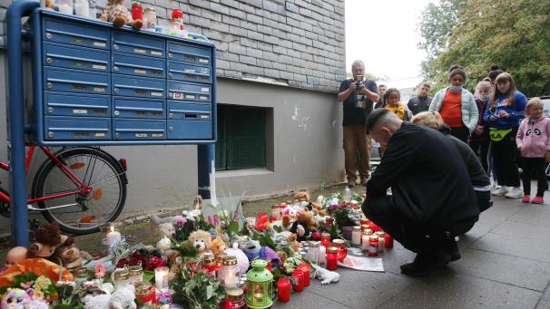 <p>Solingen: Trauende knien vor Blumen, Kerzen und Stofftieren vor dem Haus, in dem am Vortag fünf tote Kinder aufgefunden worden waren. Die Kinder waren mutmaßlich von ihrer Mutter getötet worden. Sie hatte am Donnerstag einen Suizidversuch unternommen.</p>
