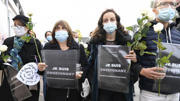 <p>Conflans-Sainte-Honorine: Die Teilnehmer einer Kundgebung vor einer Mittelschule halten nach einer brutalen Messerattacke Rosen und Schilder mit der Aufschrift „Ich bin Lehrer - Ich verteidige die Meinungsfreiheit“.</p>