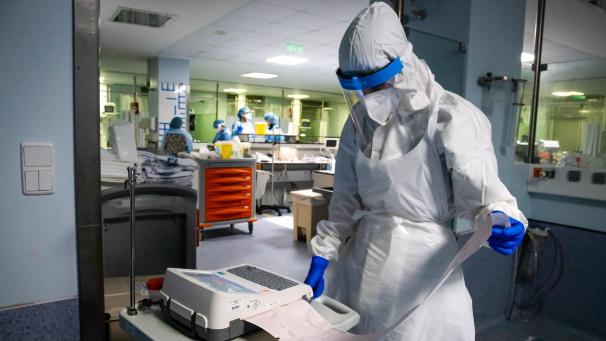 <p>Ein medizinischer Mitarbeiter in einem Schutzanzug führt im Universitätskrankenhaus von São João do Porto ein Elektrokardiogramm durch.</p>