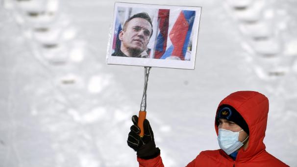 <p>Ein Demonstrant hält ein Schild mit einem Foto des Kremlkritikers Nawalny, dessen Freilassung er während eines Protests auf dem Senatsplatz fordert.</p>