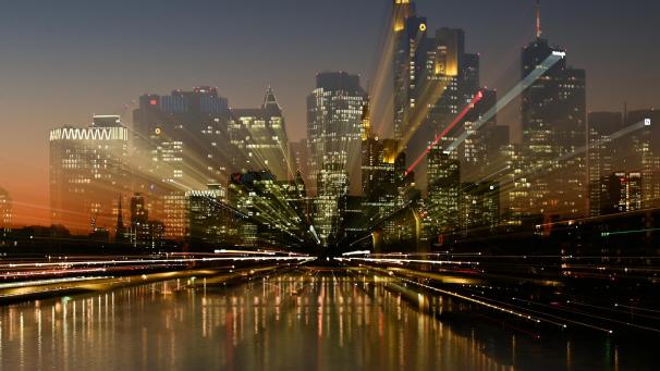 <p>Der Abendhimmel hinter den beleuchteten Hochhäusern der Frankfurter Skyline ist nach Sonnenuntergang in farbiges Licht getaucht.</p>