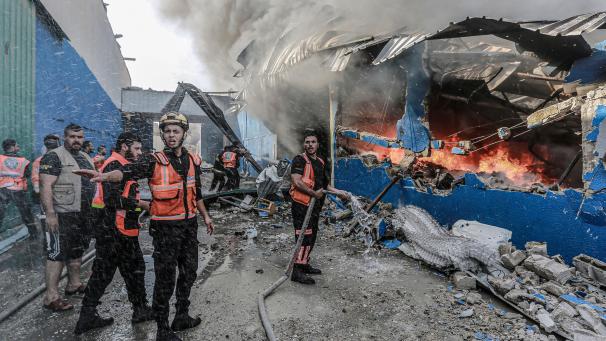 <p>Mitglieder der palästinensischen Zivilverteidigung versuchen, ein Feuer in einer Schaumstofffabrik zu löschen, nachdem diese von israelischen Artilleriegranaten getroffen worden ist.</p>