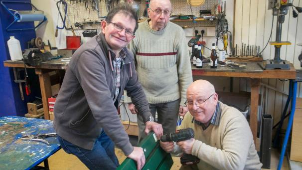 <p>Sigi Kever (rechts) montiert das Schild, das auf die Restaurierung durch die Seniorenwerkstatt hinweist.</p>