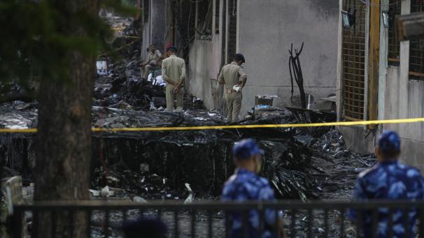 <p>Polizisten sichern die Absturzstelle eines Flugzeugs in Ahmedabad.</p>