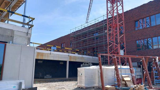 <p>Rote Klinkersteine und Betonelemente kennzeichnen das neue Schulgebäude in Herbesthal. Zum übernächsten Schuljahr soll es bezugsfertig sein.</p>