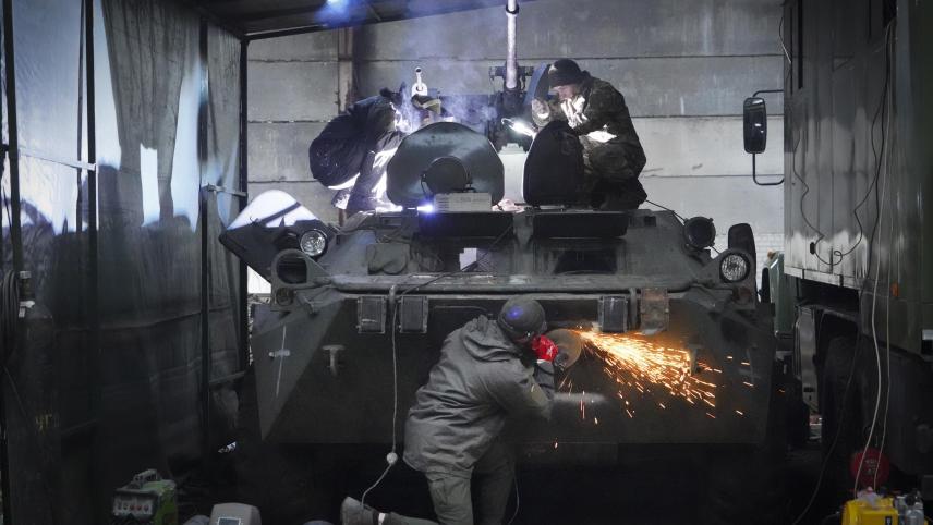 <p>Soldaten der ukrainischen Nationalgarde reparieren einen erbeuteten russischen gepanzerten Mannschaftstransportwagen.</p>